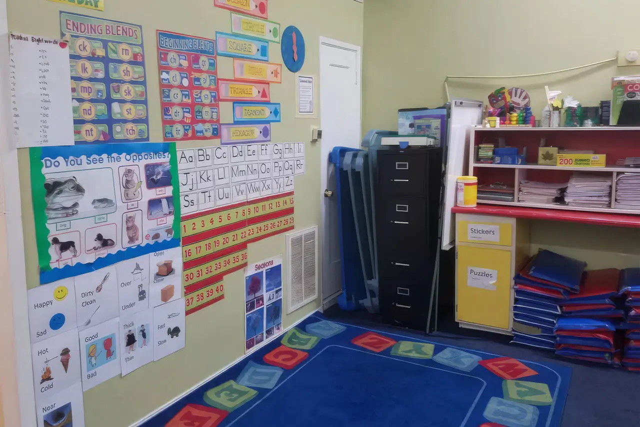 A classroom filled with various educational items and decorations displayed on the walls, creating an engaging learning environment.